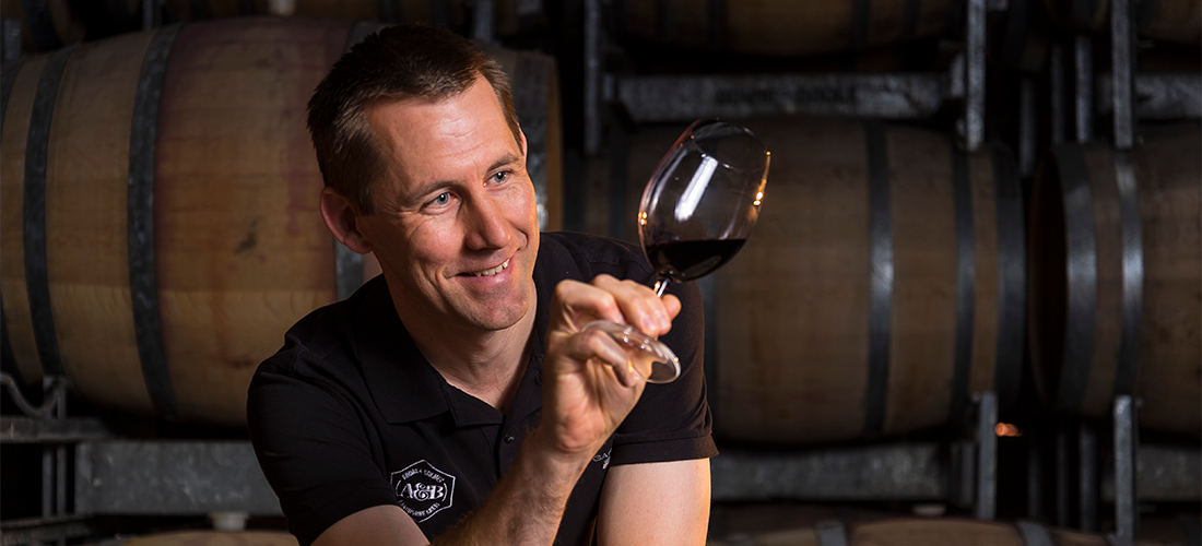 Man inspecting wine  in wine glass 